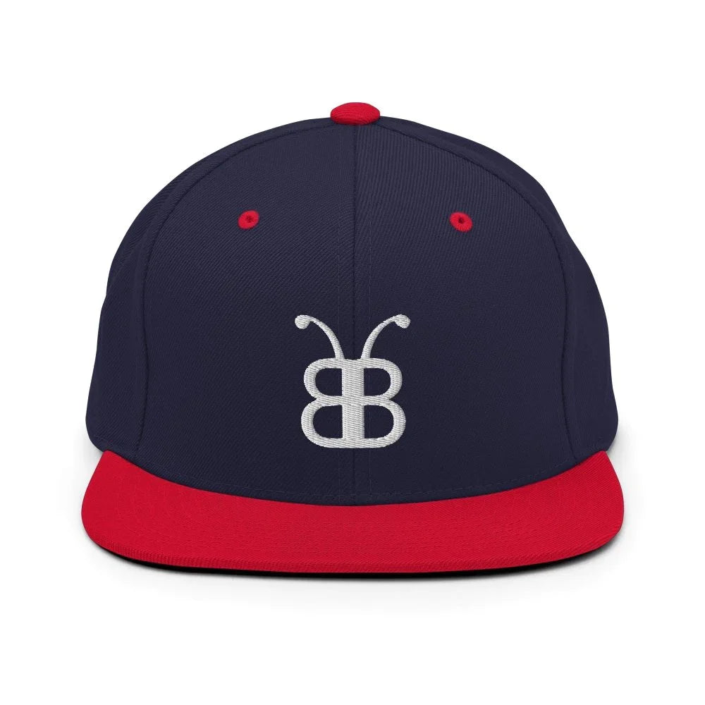 Navy blue snapback hat with red brim and white embroidered logo, streetwear style