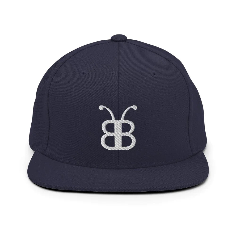 Navy blue snapback hat with white embroidered logo, streetwear style cap for urban fashion