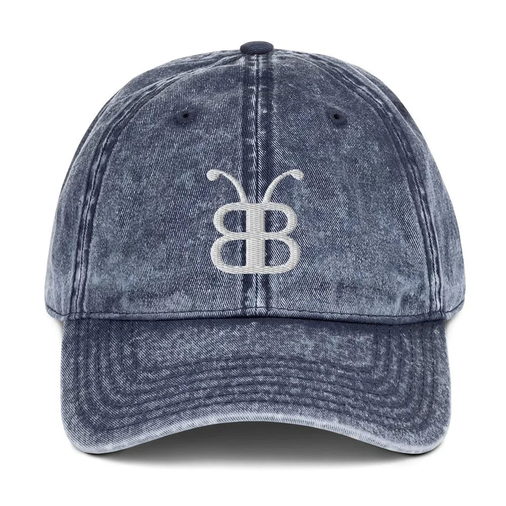 Distressed denim baseball cap with embroidered butterfly logo, streetwear style