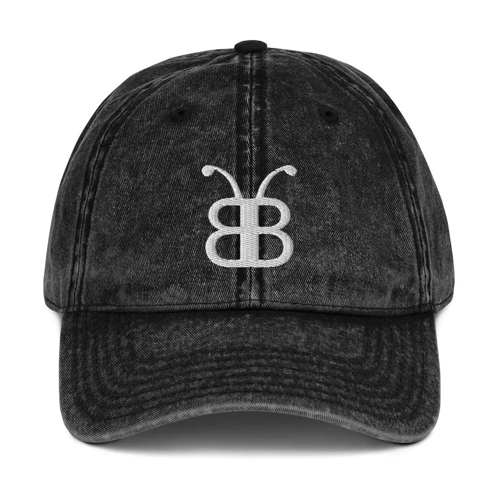 Black distressed dad hat with white embroidered butterfly logo, streetwear style